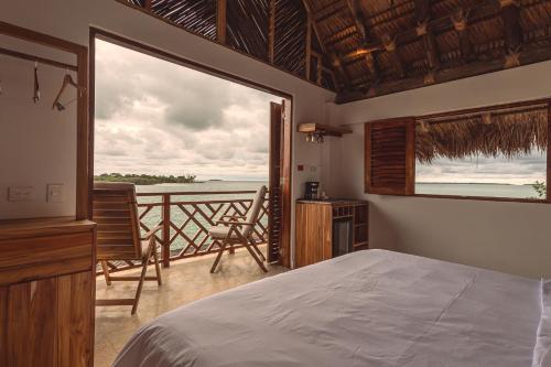 a bedroom with a bed and a view of the ocean at Islawa Soy Local - Isla Privada in Baru