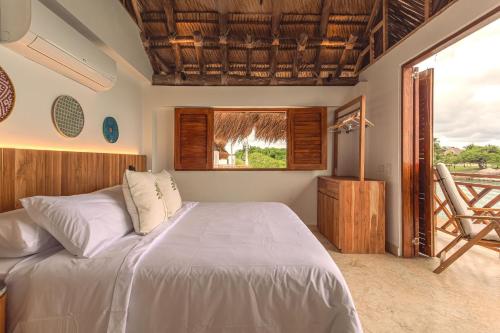 a bedroom with a large bed and a window at Islawa Soy Local - Isla Privada in Baru