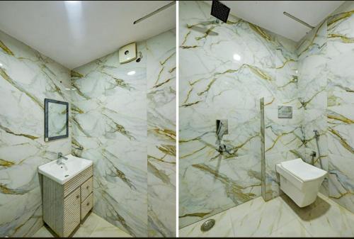 a marble bathroom with a toilet and a sink at Family Stay New Delhi by Sona Hight in New Delhi