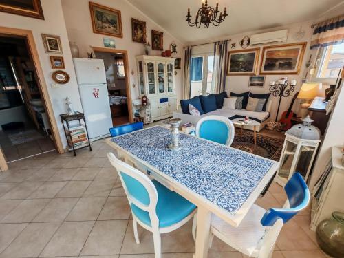 a dining room with a blue table and chairs at Apartmani Ima in Ližnjan