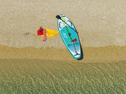 a surfboard and a kite on the beach at Ilirija Resort Hotel Kornati in Biograd na Moru