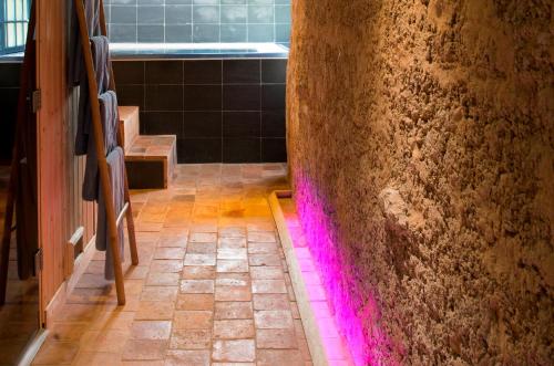 a bathroom with pink lights on the wall at Château de l'Abbaye - Teritoria in Moreilles