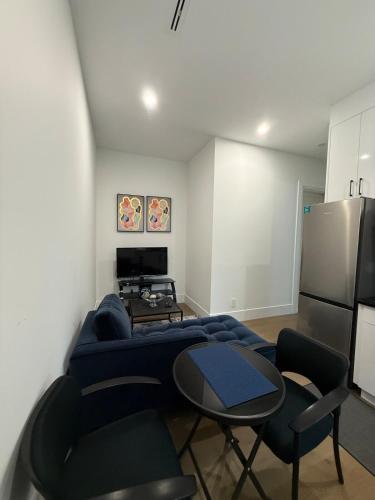a living room with a bed and a table and chairs at Calm & Cozy Private Suite in Surrey