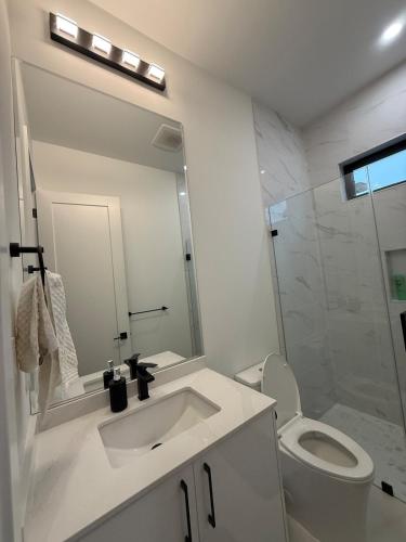 a white bathroom with a sink and a toilet at Calm & Cozy Private Suite in Surrey