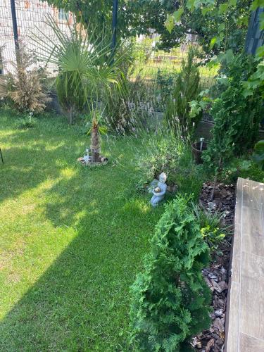 a garden with two stuffed animals in the grass at Elephant House-Sd 