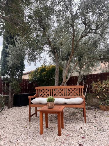 a wooden bench with a potted plant on it at La Bohème Mouriès in Mouriès
