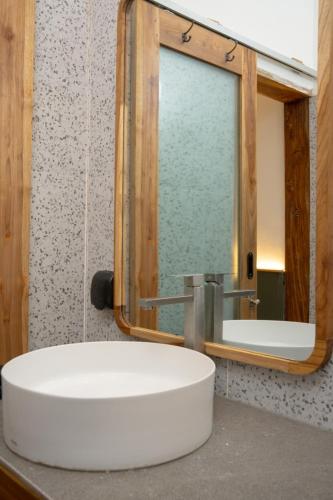 a bathroom with a white sink and a mirror at Green Hill Boutique Hotel in Labuan Bajo