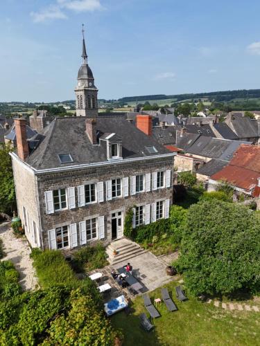 an old building with a tower on top of it at Maison d'hôtes La Doucelle culture et bien-être in Lignieres-Orgeres