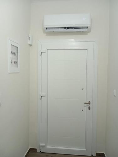 a white door with a heater on top of it at Anatoli's house in Kastoria