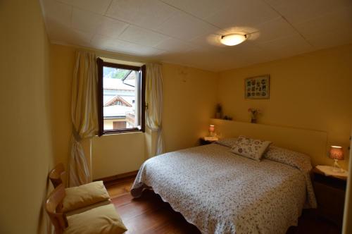 a bedroom with a bed and a window at Sabrina Fantasia in Campodolcino