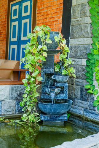 a planter with plants in it on the side of a building at Eco Hotel Black & White - Anuradhapura in Mihintale