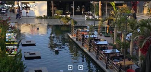 a pool of water with tables and swans in it at Garden view 3 BR 2 balconies in compound in Obour