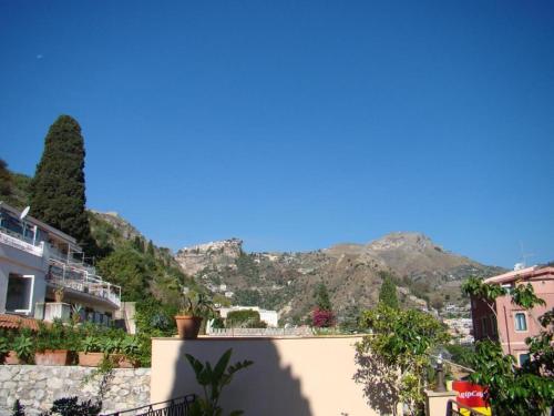 a view of the mountains from a house at Sirami Apartments in Taormina