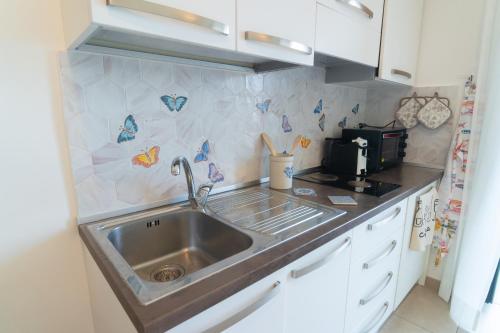 a kitchen with a sink and a microwave at Mare Luna - Enchanting sea view apartment in Ravello