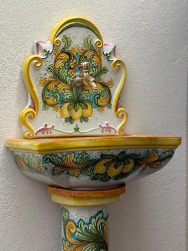 a colorful bowl on top of a shelf at Borbon Home luxury rooms & SPA in Palermo