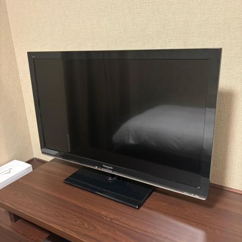 a large flat screen tv sitting on a wooden table at Dormy Inn Premium Namba Natural Hot Spring in Osaka
