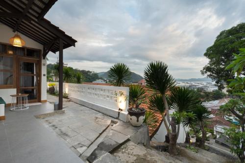 a balcony of a house with a view of the city at Green Hill Boutique Hotel in Labuan Bajo