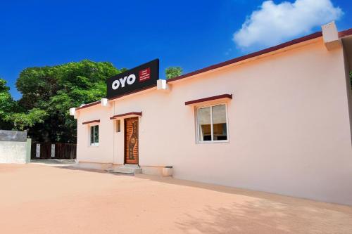 a white building with a qop sign on it at Hotel O Shree Jagannath Residency in Khandagiri