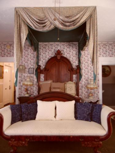 a bedroom with a bed with a canopy at Topaz Motel - Flagler Beach in Flagler Beach