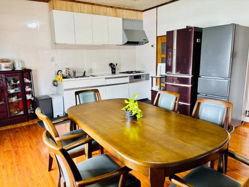 a kitchen with a wooden table with chairs around it at 和邸 和楽 Waraku in Kurume