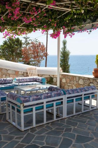 a couple of chairs and a table on a patio at Aigaio View Studios & Rooms in Azolimnos