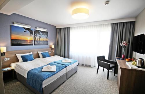 Кровать или кровати в номере WIND Hotel