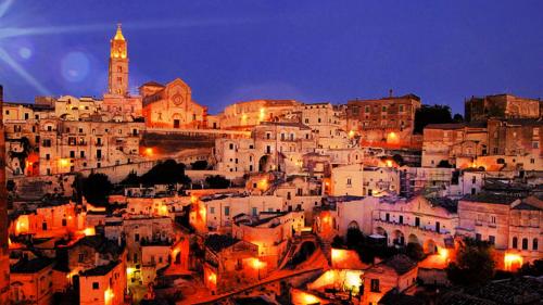 a view of a city at night at La Casa Di Rosa in Matera
