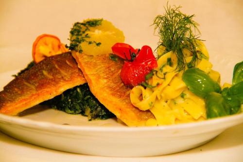 a white plate of food on a table at Hotel Restaurant Falken in Baiersbronn