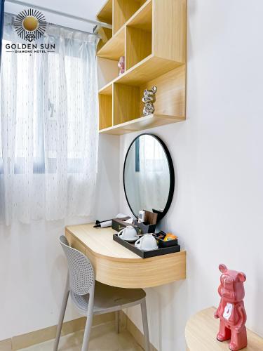 a dressing table with a mirror and a chair at Golden Sun Hotel Apartments 5 in Ho Chi Minh City