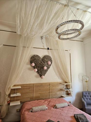 a bedroom with two hearts hanging on the wall at Casale D' Or in Palermo