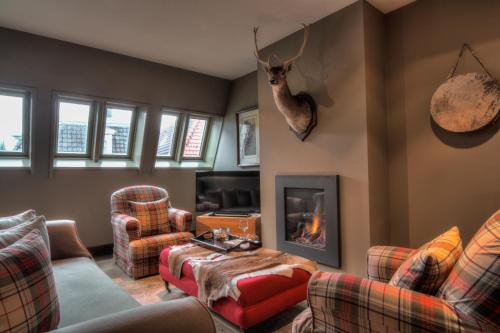 a living room filled with furniture and a fire place at Bliss Boutique Hotel in Breda