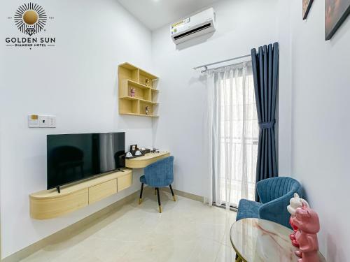 a living room with a tv and a desk at Golden Sun Hotel Apartments 5 in Ho Chi Minh City