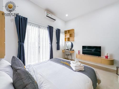 a bedroom with a bed and a flat screen tv at Golden Sun Hotel Apartments 5 in Ho Chi Minh City