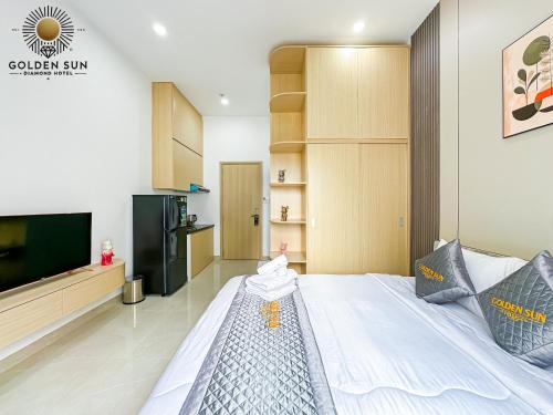 a bedroom with a large bed and a flat screen tv at Golden Sun Hotel Apartments 5 in Ho Chi Minh City