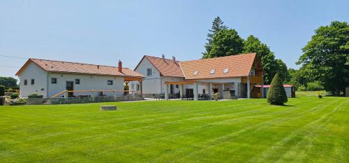 a house with a large lawn in front of it at U rybníka Smrčná in Nová Bystřice