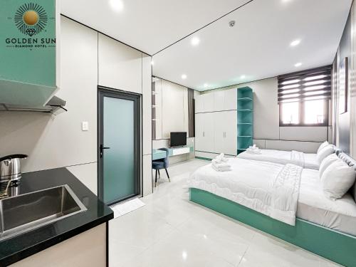 a bedroom with a bed and a sink and a kitchen at Golden Sun Hotel Apartments 5 in Ho Chi Minh City