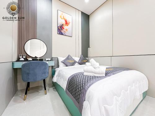 a bedroom with a bed and a desk and a mirror at Golden Sun Hotel Apartments 5 in Ho Chi Minh City