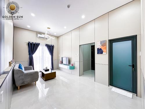 a living room with a chair and a television at Golden Sun Hotel Apartments 5 in Ho Chi Minh City