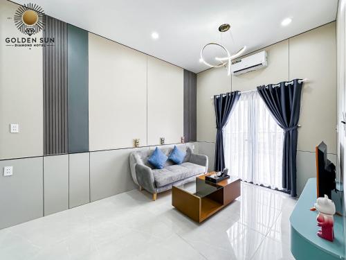 a living room with a couch and a table at Golden Sun Hotel Apartments 5 in Ho Chi Minh City