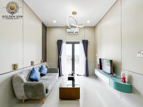 a living room with a couch and a tv at Golden Sun Hotel Apartments 5 in Ho Chi Minh City