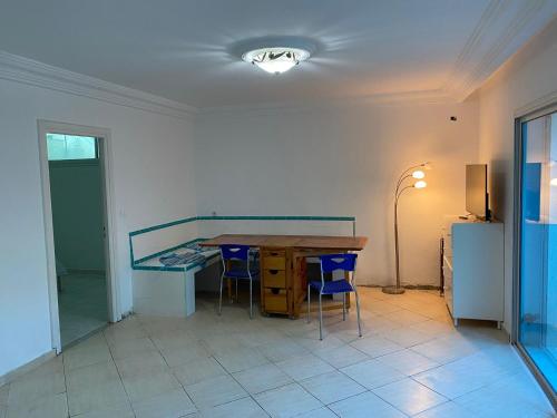 a room with a desk and chairs and a table at Habibi-Danydan La Chebba in Chebba