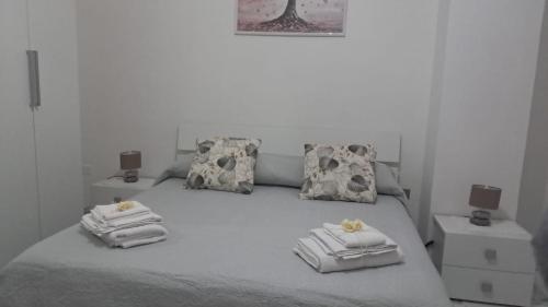 a bedroom with a bed with two towels on it at Giaro's Home in Pompei