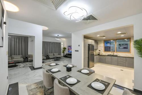 a dining room with a table and a kitchen at Harf-7821 Townhouse - Raha Gardens in Abu Dhabi