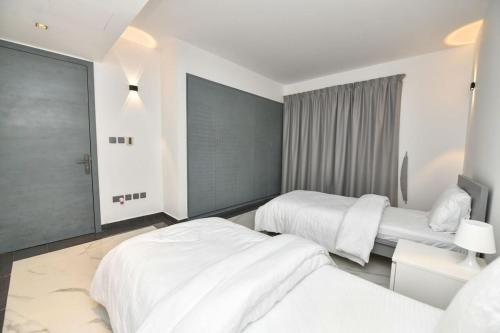 Postel nebo postele na pokoji v ubytování Harf-7821 Townhouse - Raha Gardens