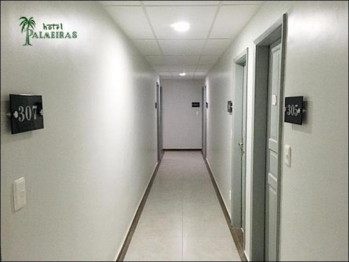 an empty hallway in a building with a hallway at Hotel Palmeiras Ltda in Duque de Caxias