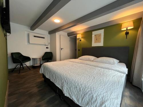 a bedroom with a bed and two chairs in it at Central Guest Rooms in Amsterdam