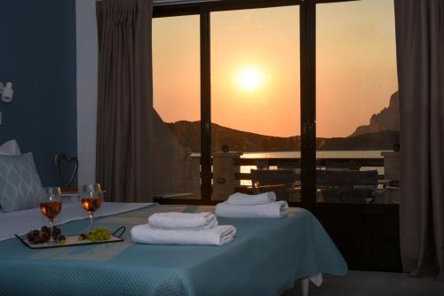 a room with a table with towels and wine glasses at Australia Apartments in Kalymnos