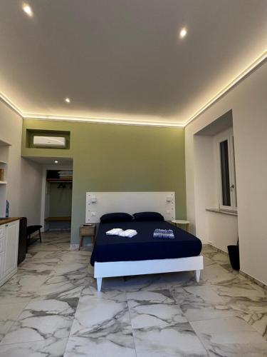 a bedroom with a bed in a room with a marble floor at Casa del Corso in Parghelia
