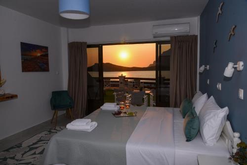 a room with a bed with a view of the ocean at Australia Apartments in Kalymnos