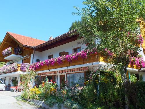 a building with flowers on the side of it at Gästehaus Amort in Ramsau